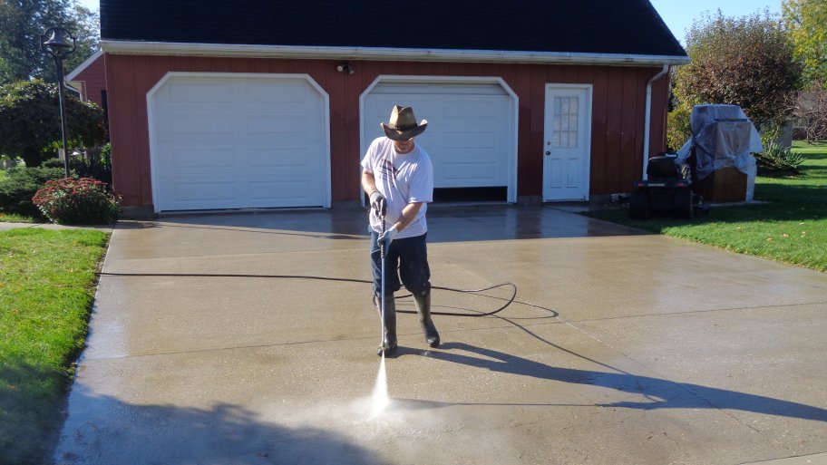a pressure washing nozzle spraying vinyl siding